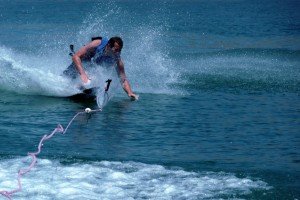 man falling down into the lake while he's water skiiing