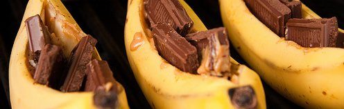 ripe bananas split down the middle with chocolate and peanut butter inside