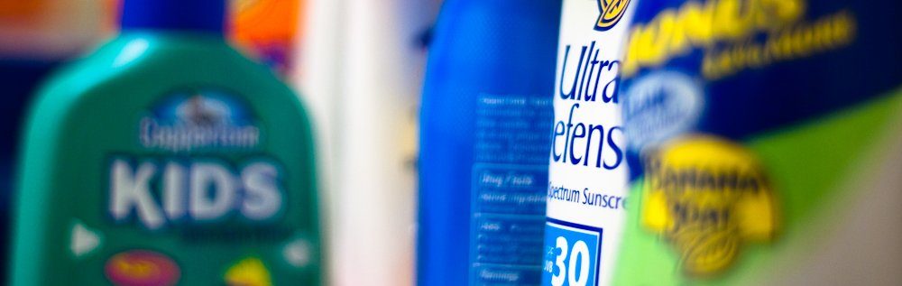 shelf with many kinds of sunscreens on it