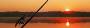 fishing rod ready to be cast as the sun comes up