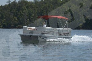 pontoon boat on the lake with a red bimini top