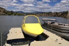 yellow boat cover on a boat with a tower that is moored