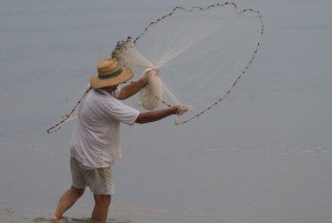 man throwing a casting net