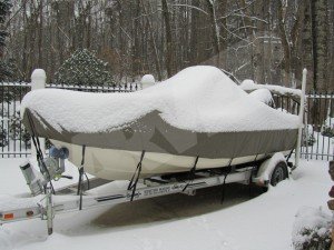 boat cover on boat that is covered in snow